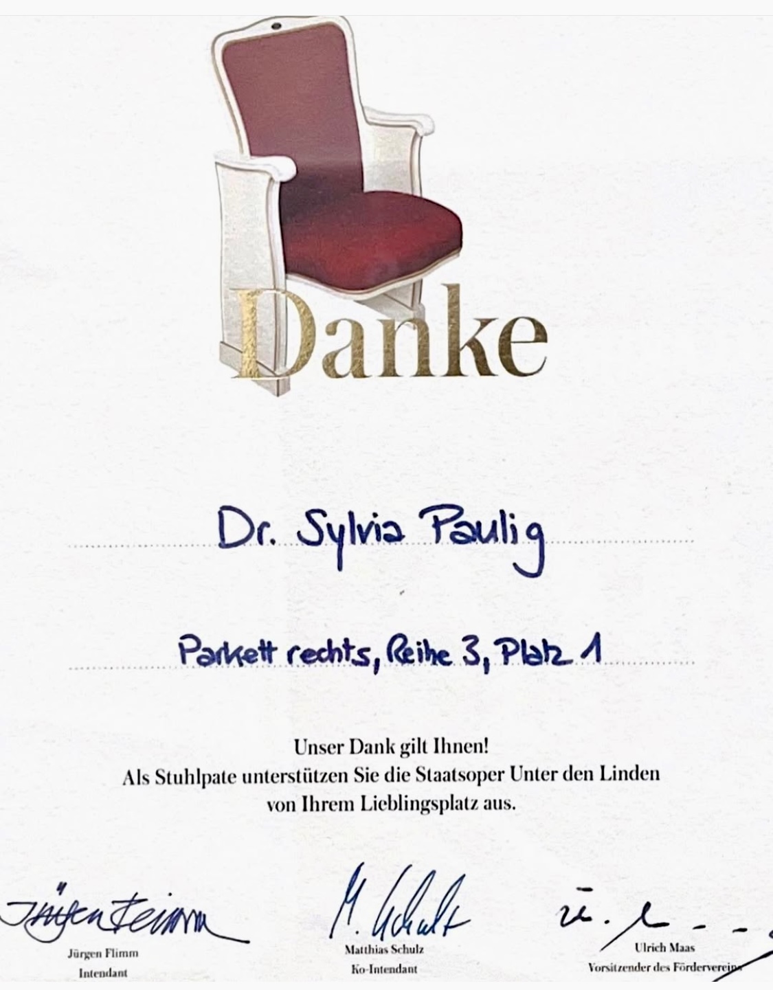 Eine Dankeskarte mit rotem Stuhl und handschriftlichem Text.
